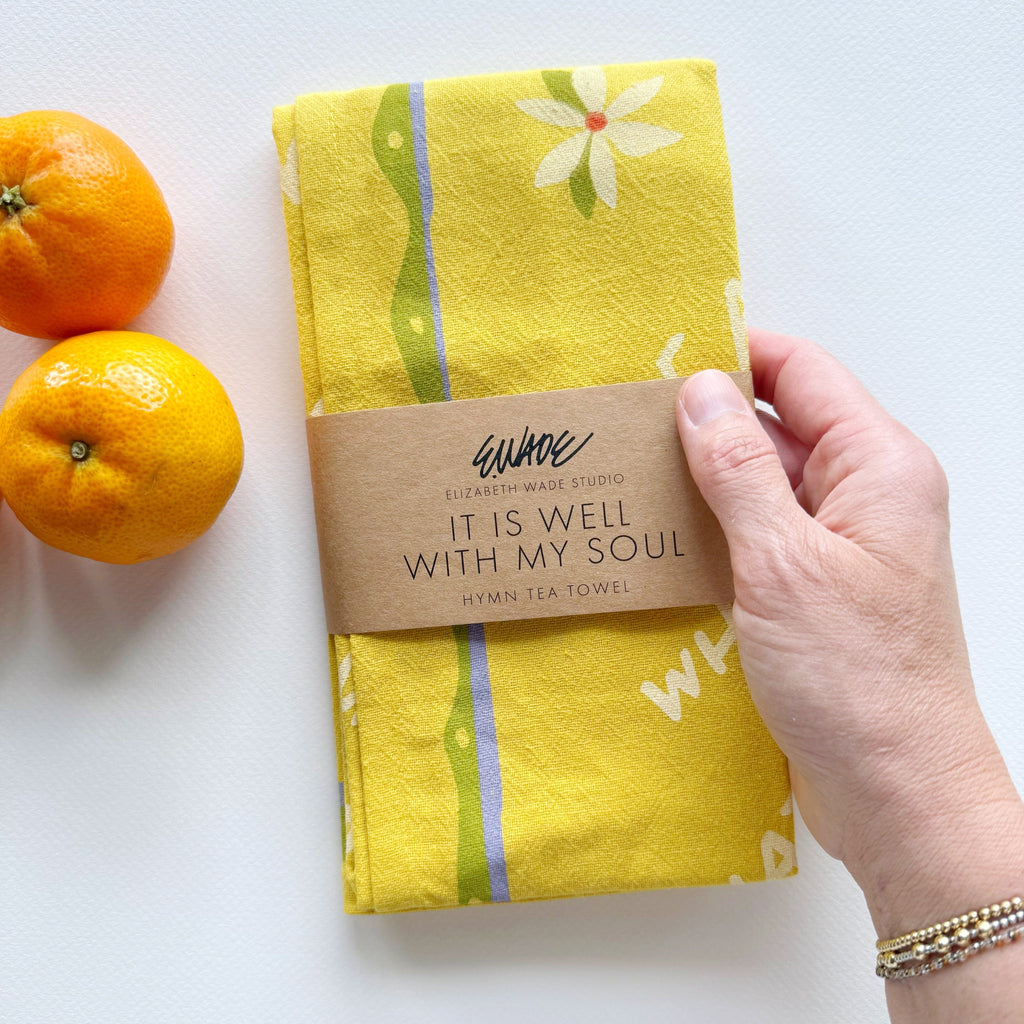 Yellow towel with orange fruit design featuring the hymn "It is Well with My Soul"